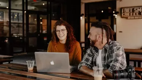 woman and man chatting over a laptop